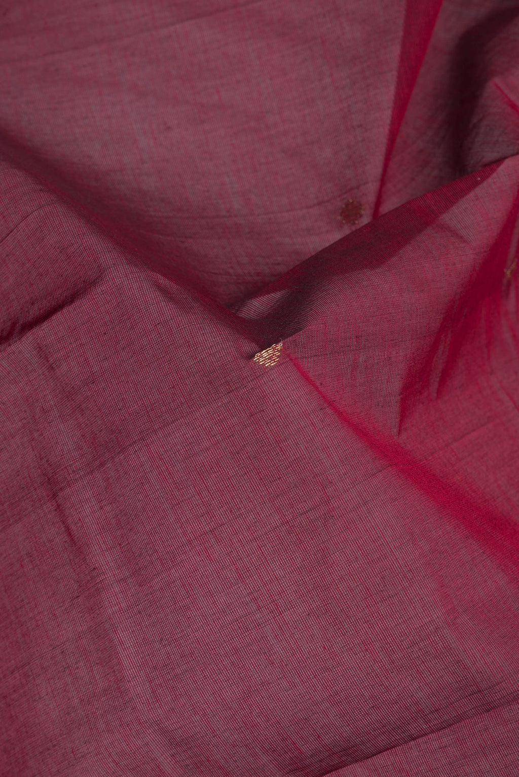 Close up of Maroon Kanchi Cotton Saree with Zari Butta on the body and Zari Border.  displaying folds