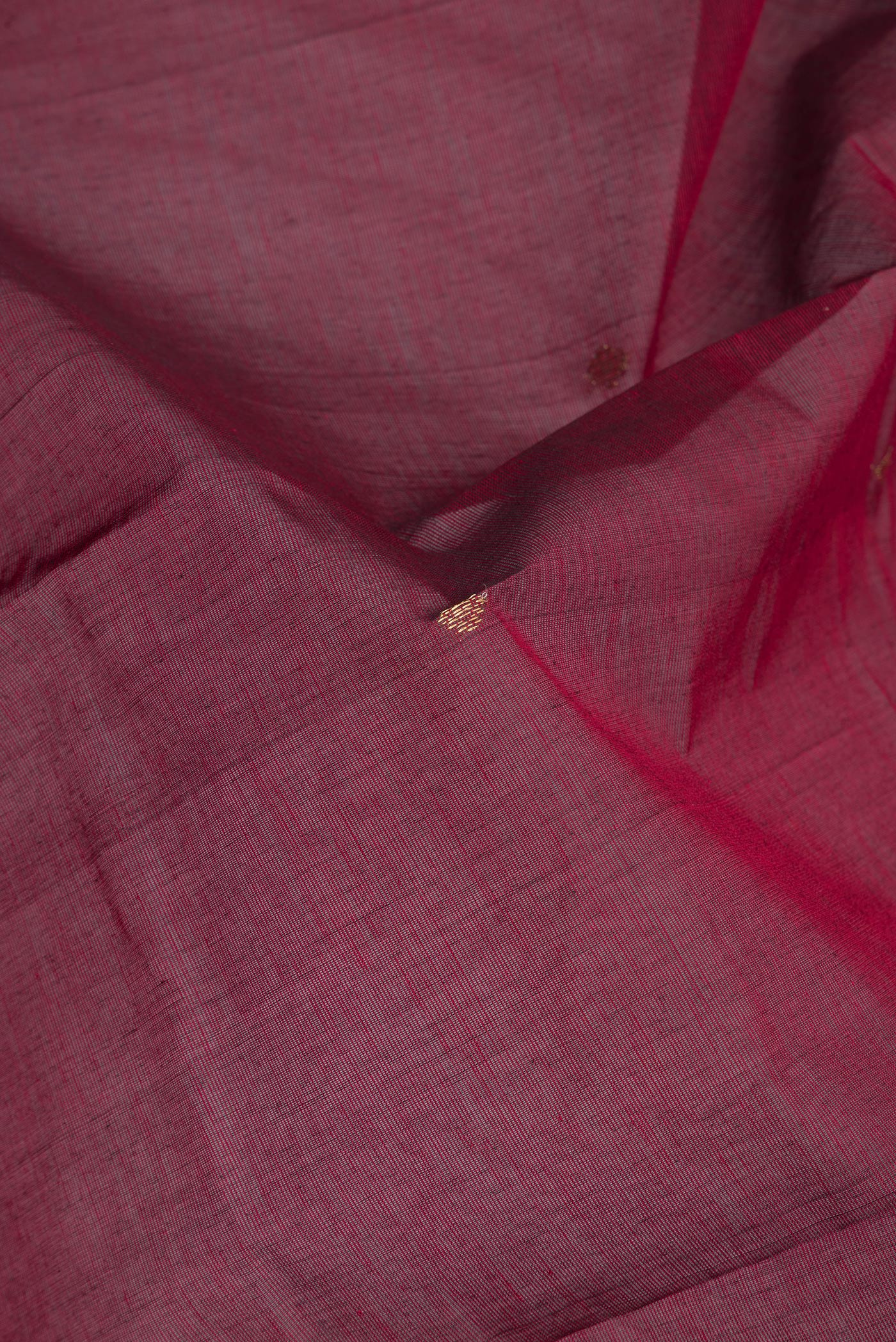 Close up of Maroon Kanchi Cotton Saree with Zari Butta on the body and Zari Border.  displaying folds