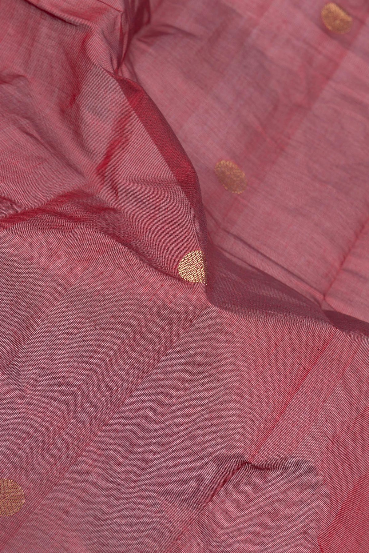 Close up of Maroon Kanchi Cotton Saree with Zari Butta on the body and Temple Border.  displaying folds