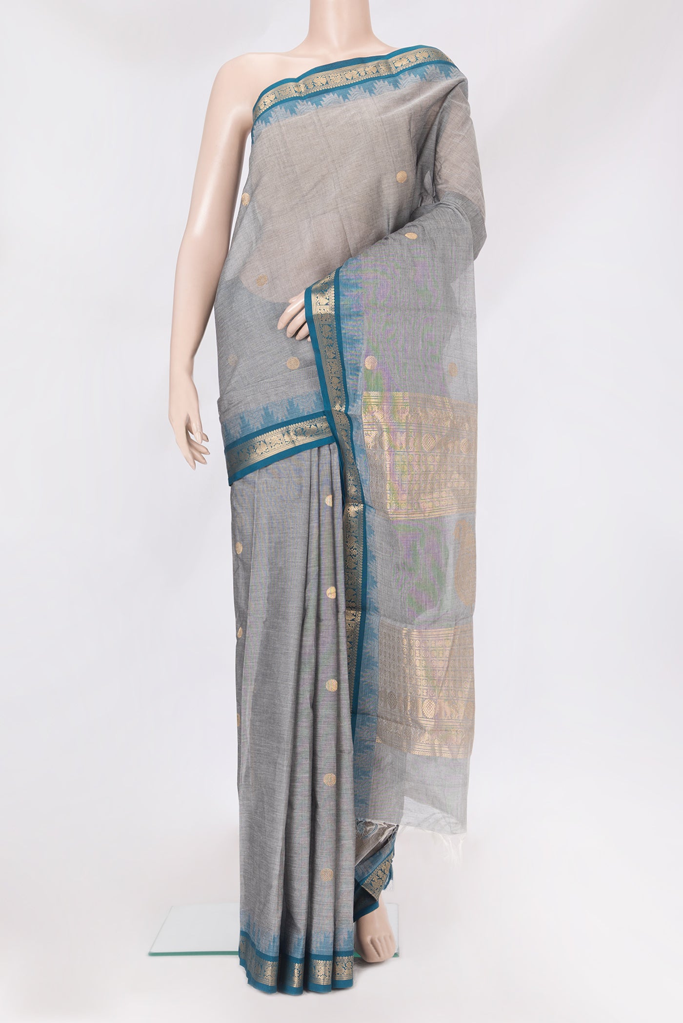 Grey Kanchi Cotton Saree with Zari Butta on the body and Temple Border.  displayed on a mannequin
