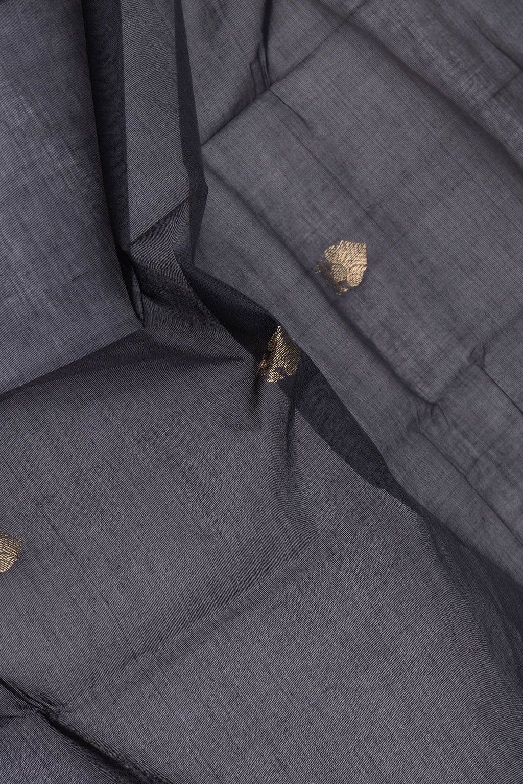 Close up of Black Kanchi Cotton Saree with Zari Butta on the body and Zari Border.  displaying folds