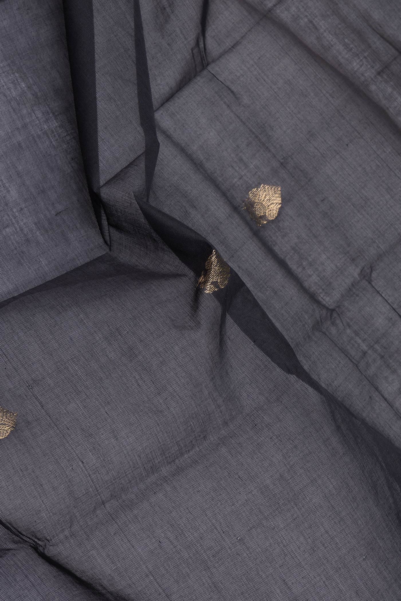 Close up of Black Kanchi Cotton Saree with Zari Butta on the body and Zari Border.  displaying folds
