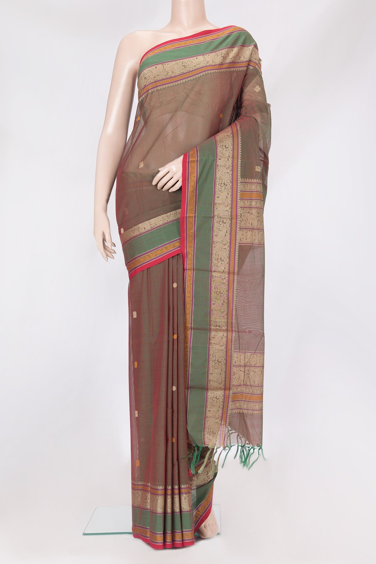Green Dual Tone Kanchi Cotton Saree with Thread Butta on the body and Thread Border.  displayed on a mannequin