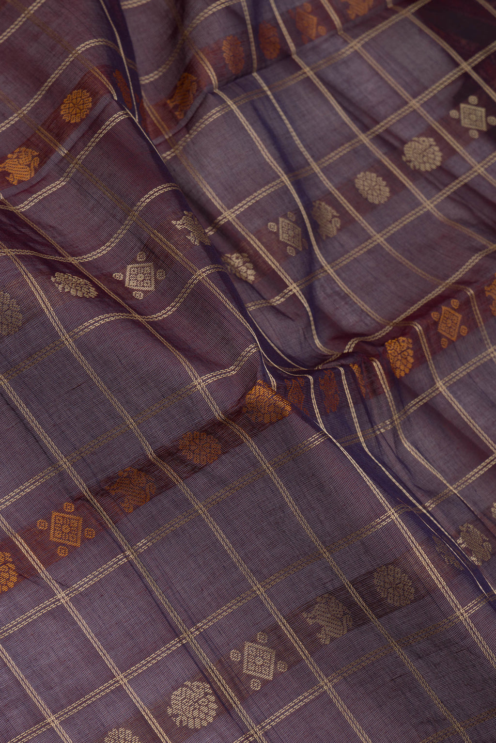 Close up of Burgundy Dual Tone Kanchi Cotton Saree with Thread Butta on the body and Zari And Thread Border.  displaying folds