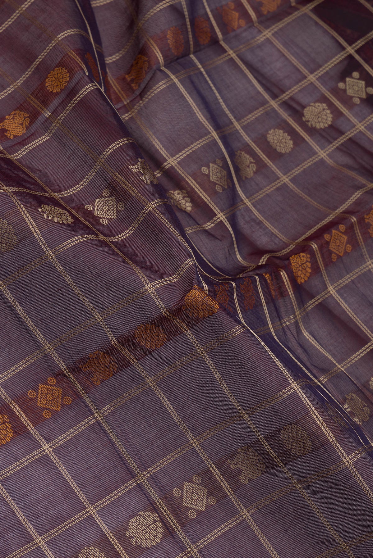 Close up of Burgundy Dual Tone Kanchi Cotton Saree with Thread Butta on the body and Zari And Thread Border.  displaying folds