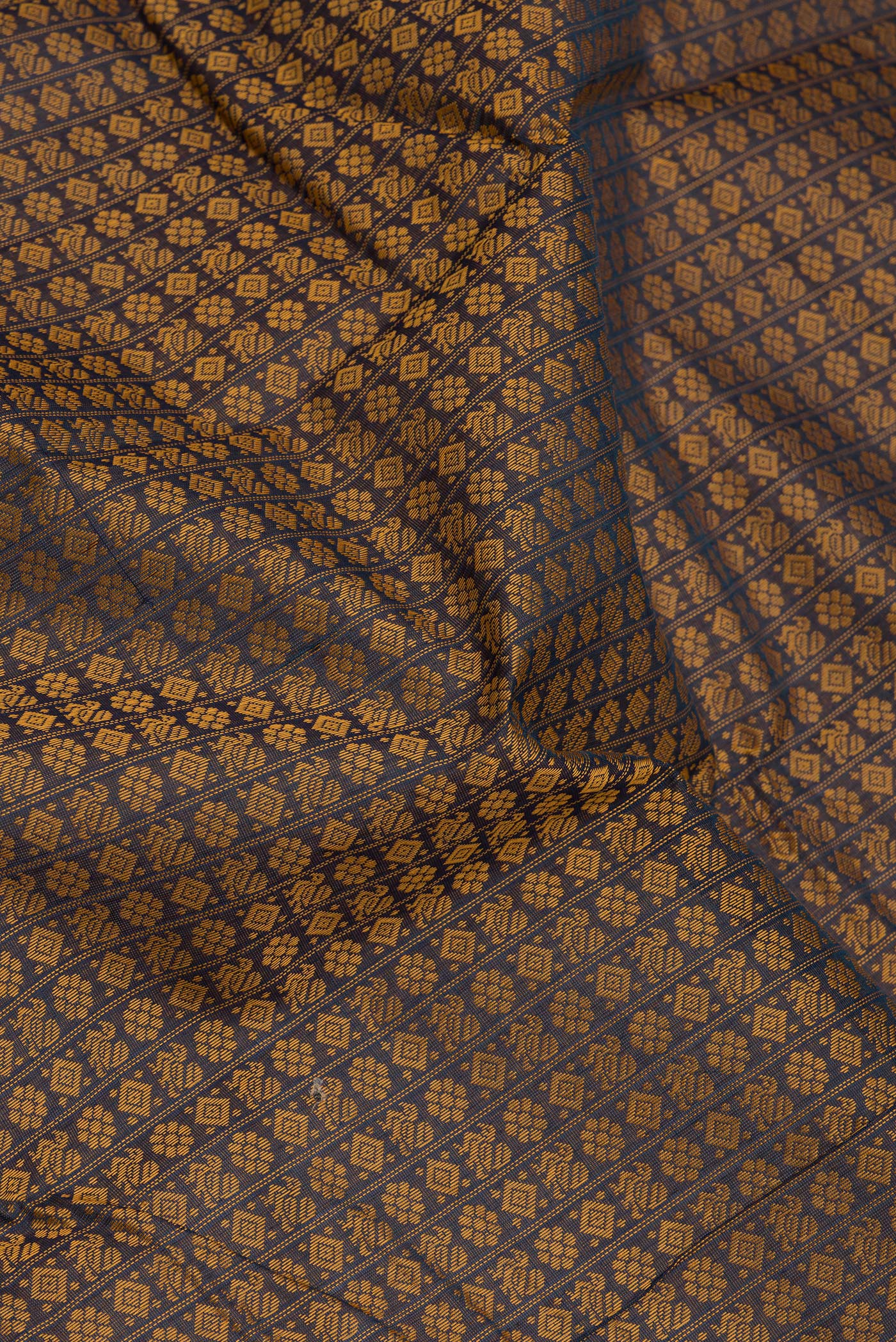 Close up of Navy Blue Dual Tone Kanchi Cotton Saree with Thread Butta on the body and Zari And Thread Border.  displaying folds