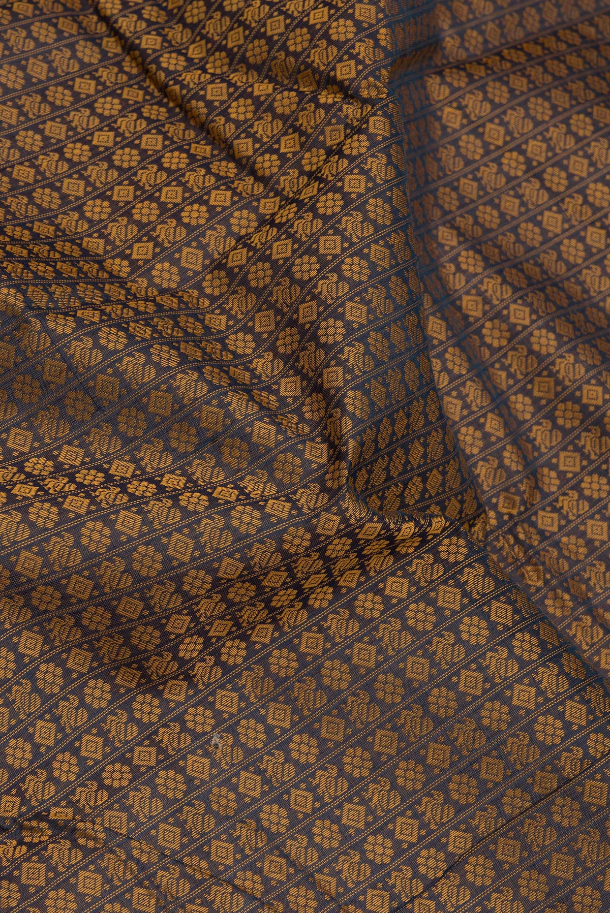 Close up of Navy Blue Dual Tone Kanchi Cotton Saree with Thread Butta on the body and Zari And Thread Border.  displaying folds