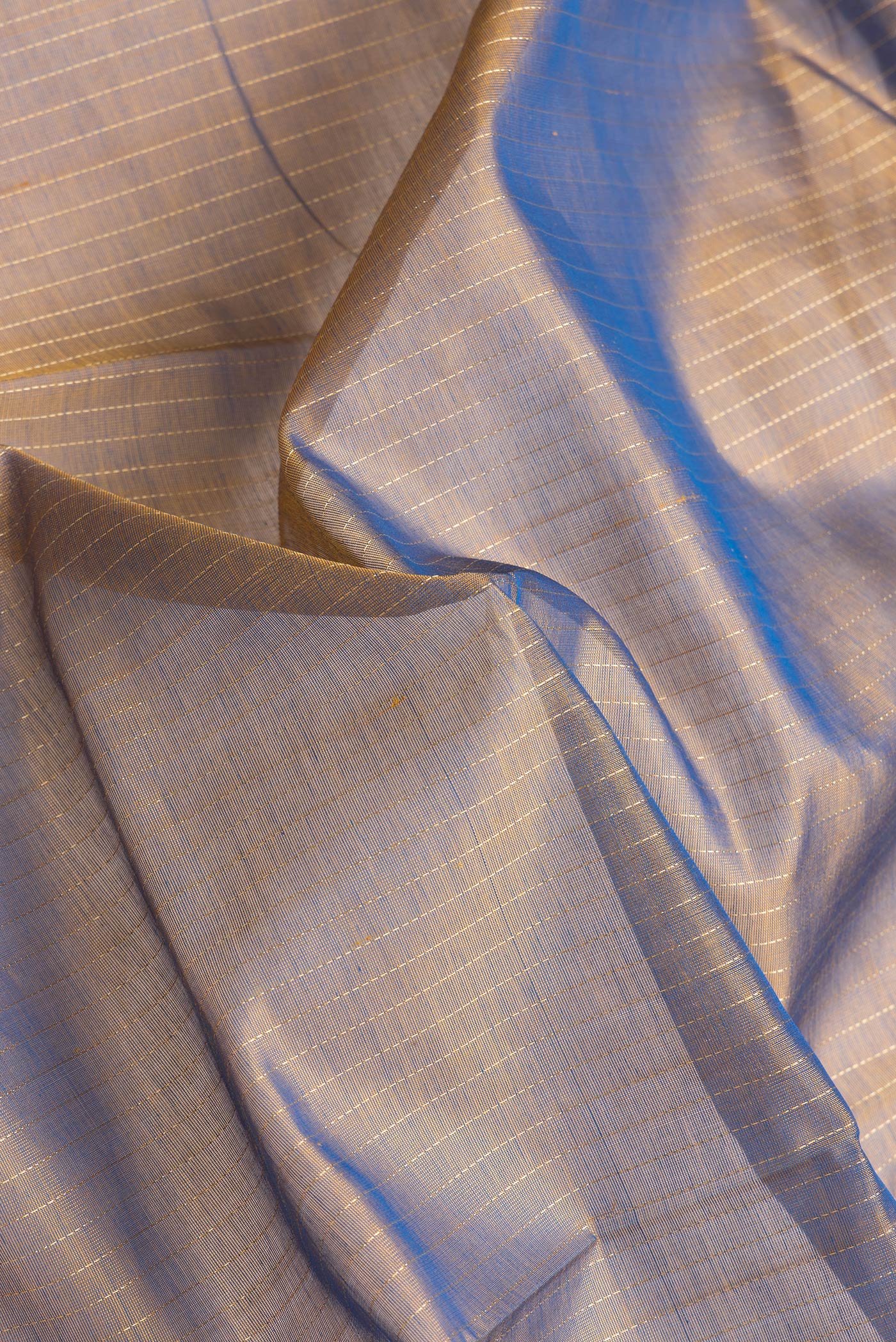 Close up of Brown Dual Tone Silk Cotton Saree with Stripes on the body and Zari Border.  displaying folds
