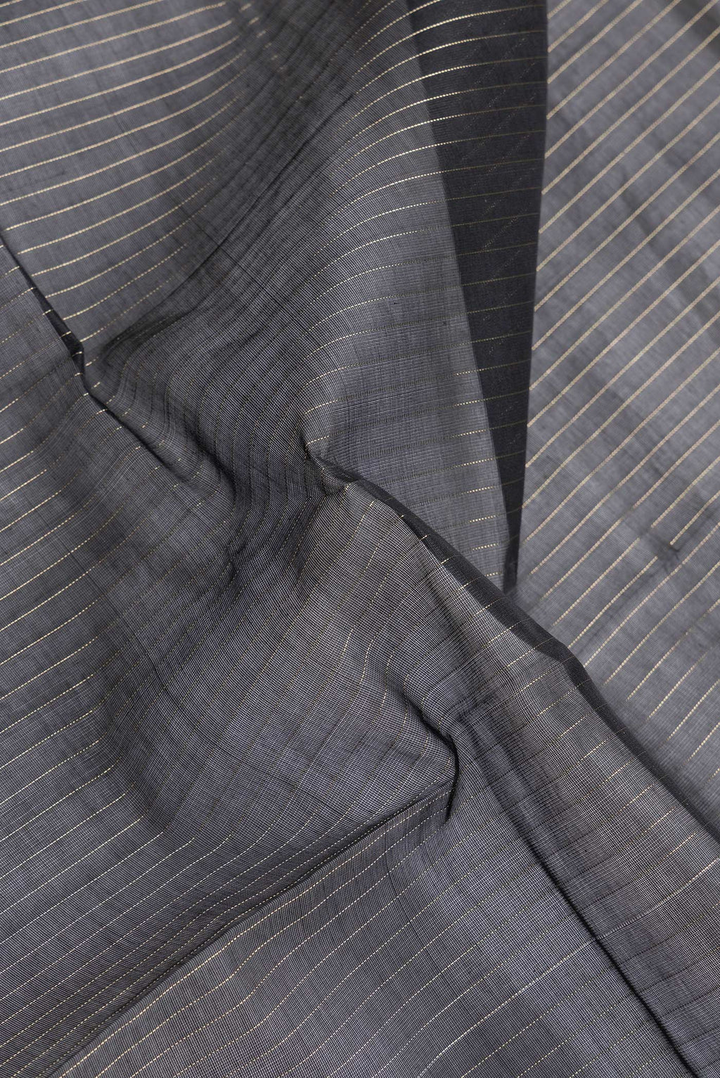 Close up of Black Dual Tone Silk Cotton Saree with Stripes on the body and Zari Border.  displaying folds
