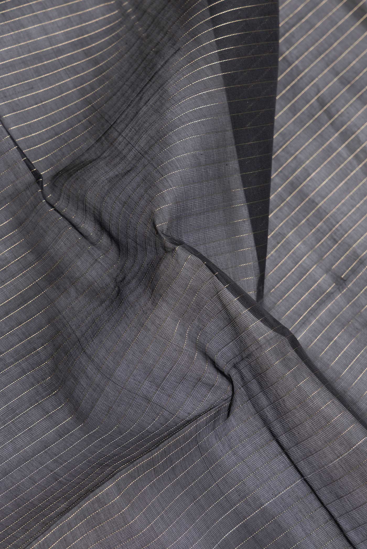 Close up of Black Dual Tone Silk Cotton Saree with Stripes on the body and Zari Border.  displaying folds