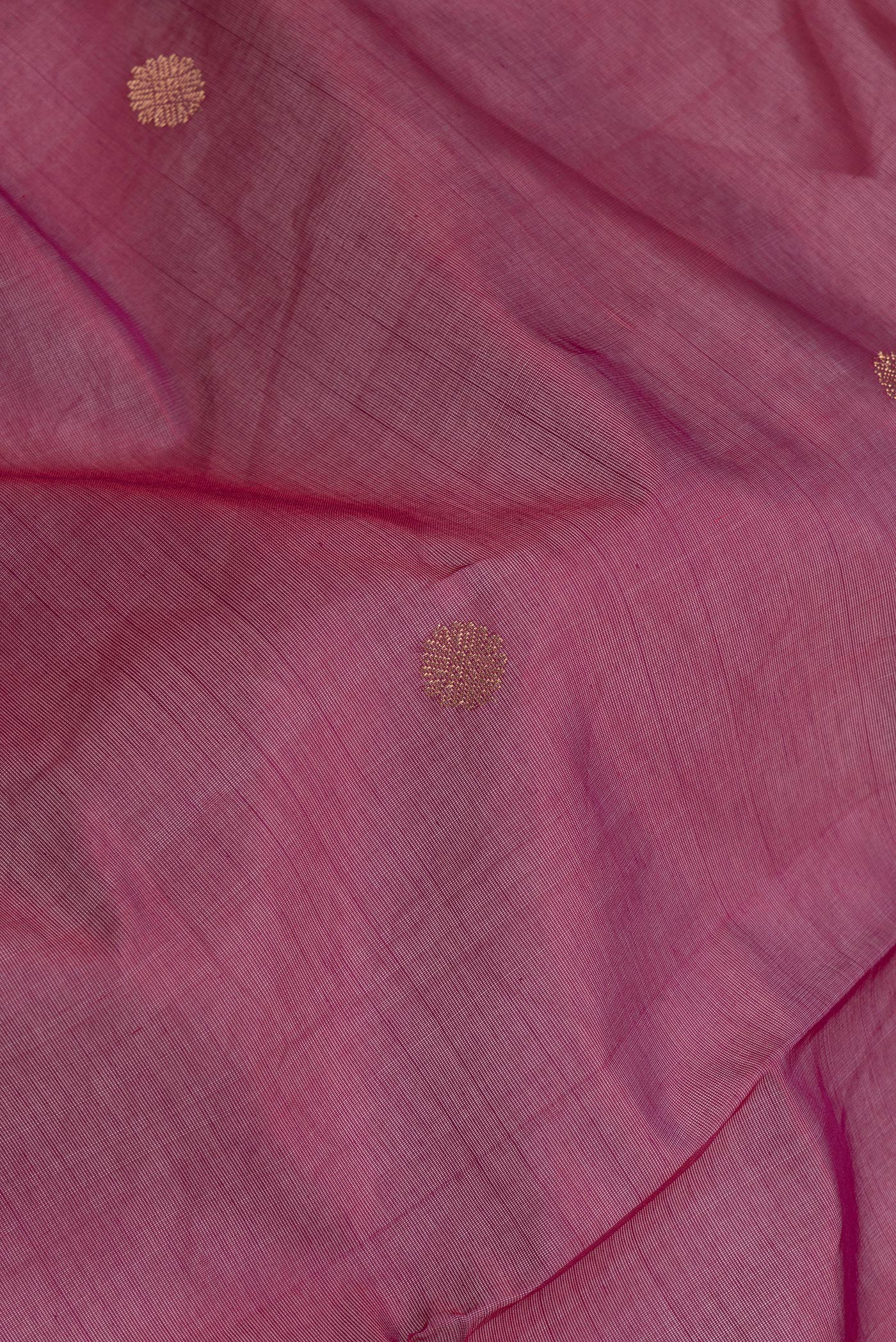 Close up of Pink Dual Tone Silk Cotton Saree with Zari Butta on the body and Zari Border.  displaying folds
