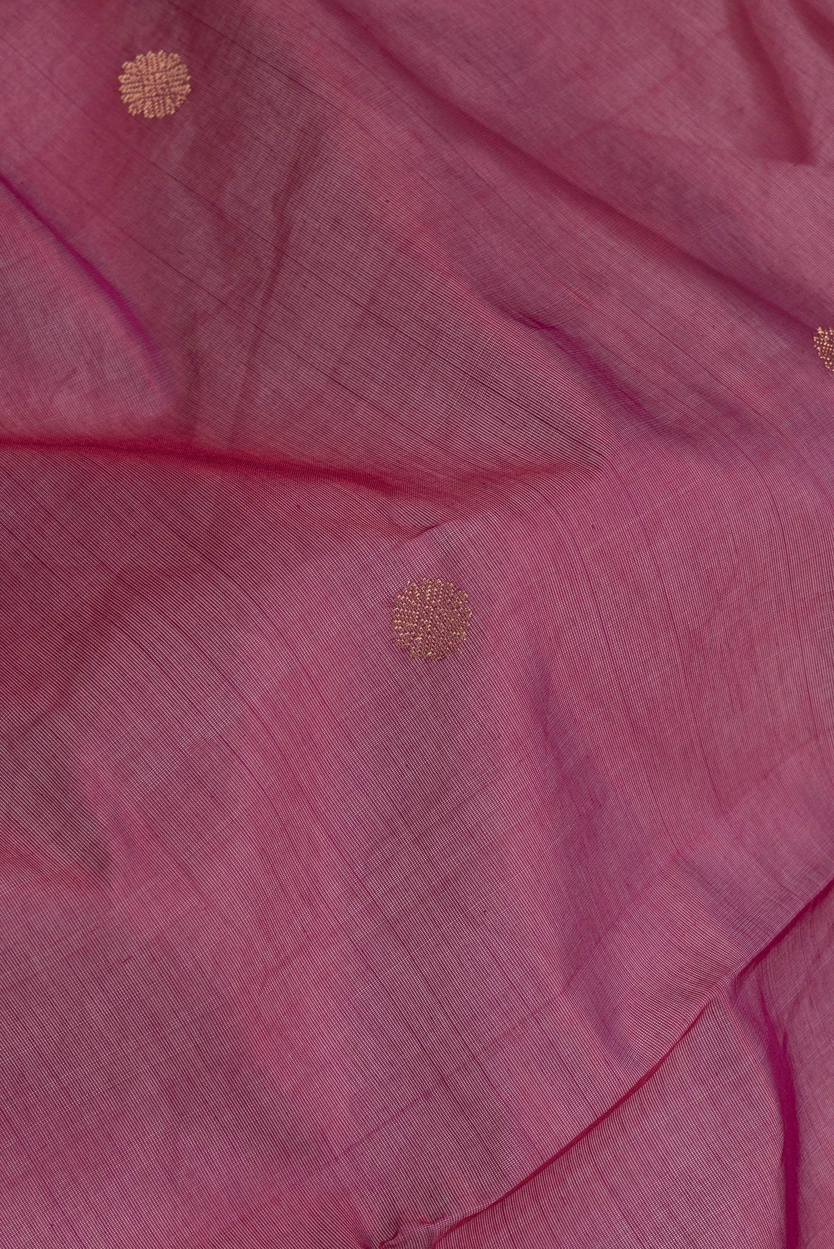Close up of Pink Dual Tone Silk Cotton Saree with Zari Butta on the body and Zari Border.  displaying folds
