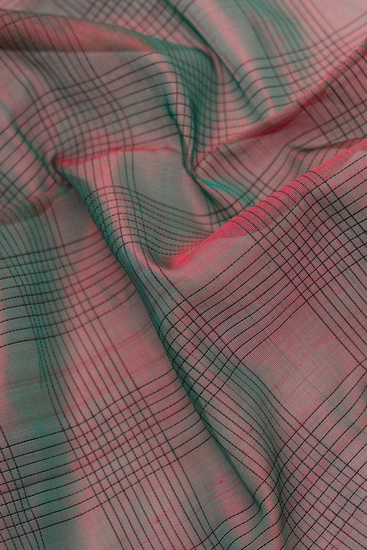 Close up of Green Dual Tone Silk Cotton Saree with Plain Body and Zari Border.  displaying folds