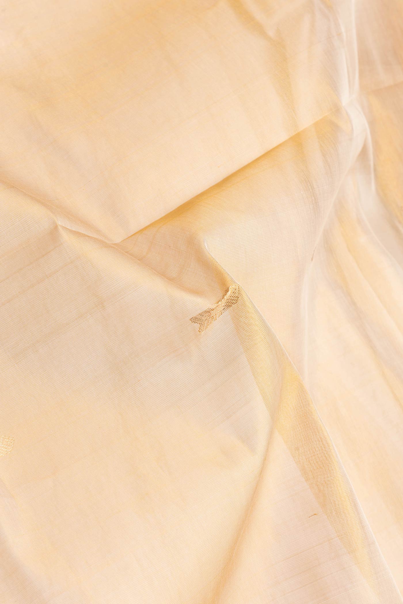 Close up of Sandal Dual Tone Silk Cotton Saree with Zari Butta on the body and Zari Border.  displaying folds
