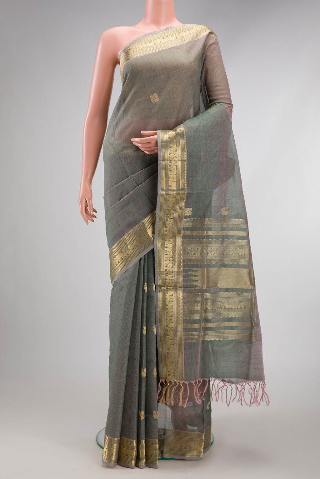 Grey with Green Color Silk Cotton Saree with Zari Butta on the body and Zari Border.  displayed on a mannequin