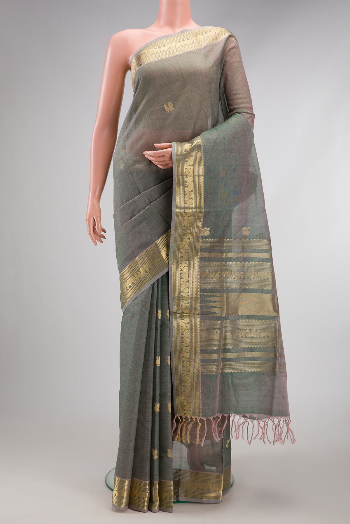 Grey with Green Color Silk Cotton Saree with Zari Butta on the body and Zari Border.  displayed on a mannequin
