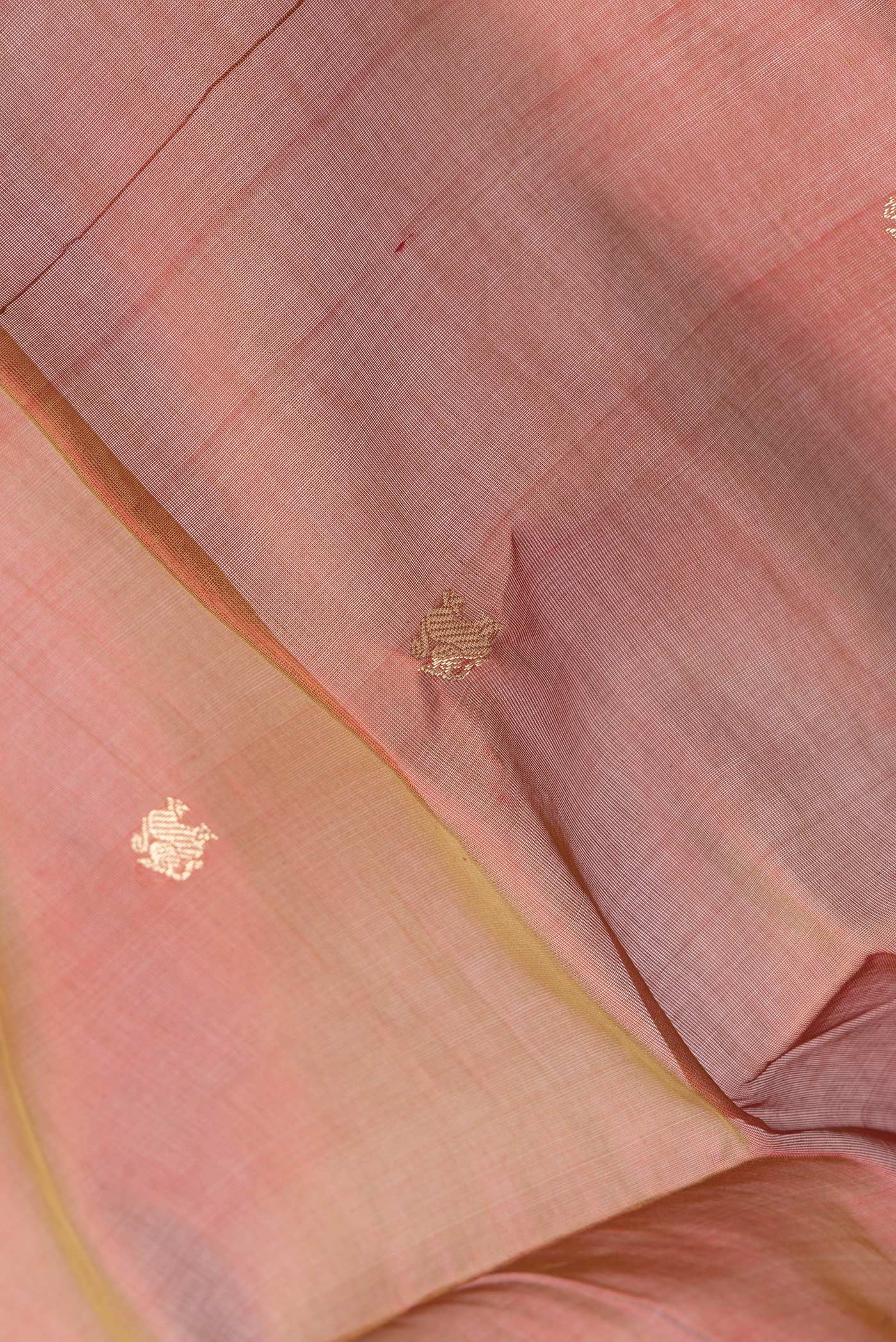 Close up of Maroon Dual Tone Silk Cotton Saree with Zari Butta on the body and Zari Border.  displaying folds