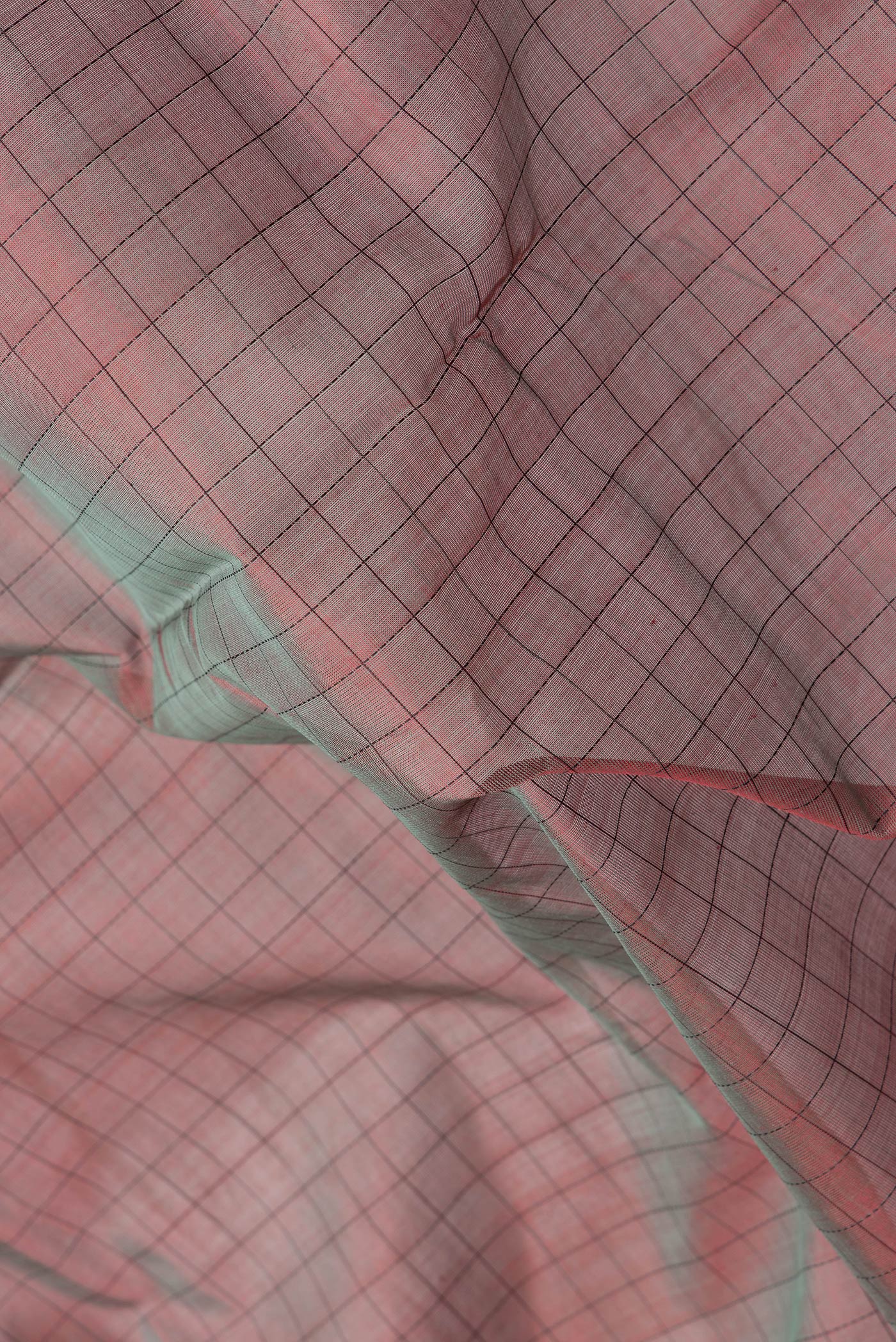 Close up of Mehandi Green Dual Tone Silk Cotton Saree with Checked design on the body and Fancy Border.  displaying folds