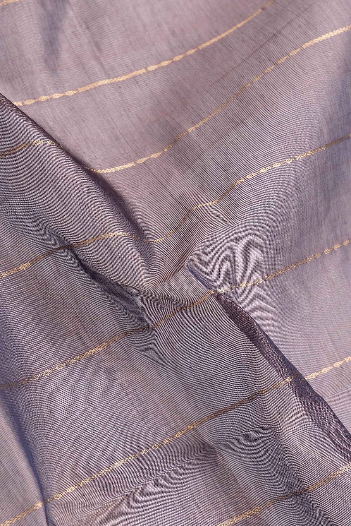 Close up of Burgundy Dual Tone Silk Cotton Saree with Stripes on the body and Zari Border.  displaying folds