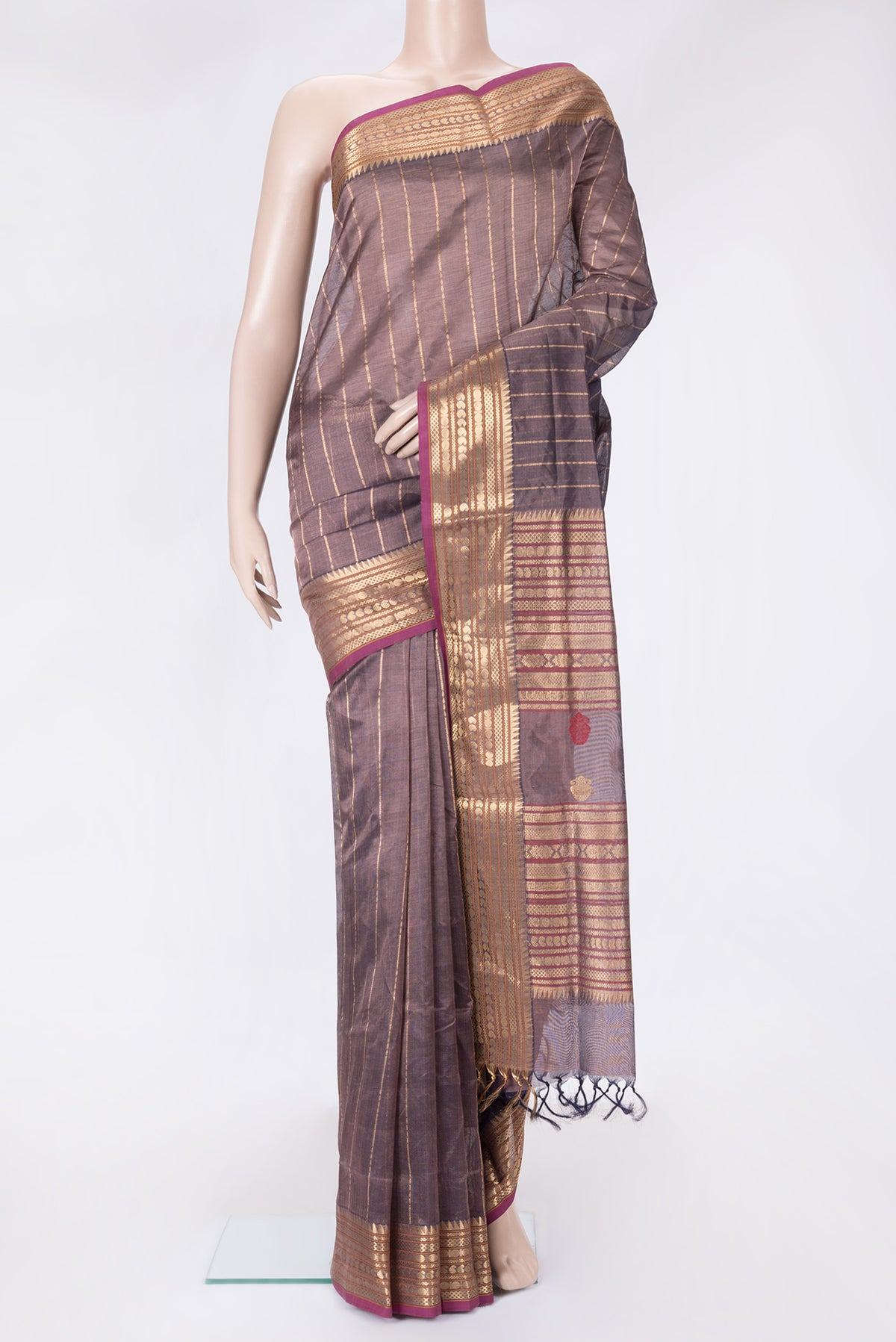 Burgundy Dual Tone Silk Cotton Saree with Stripes on the body and Zari Border.  displayed on a mannequin