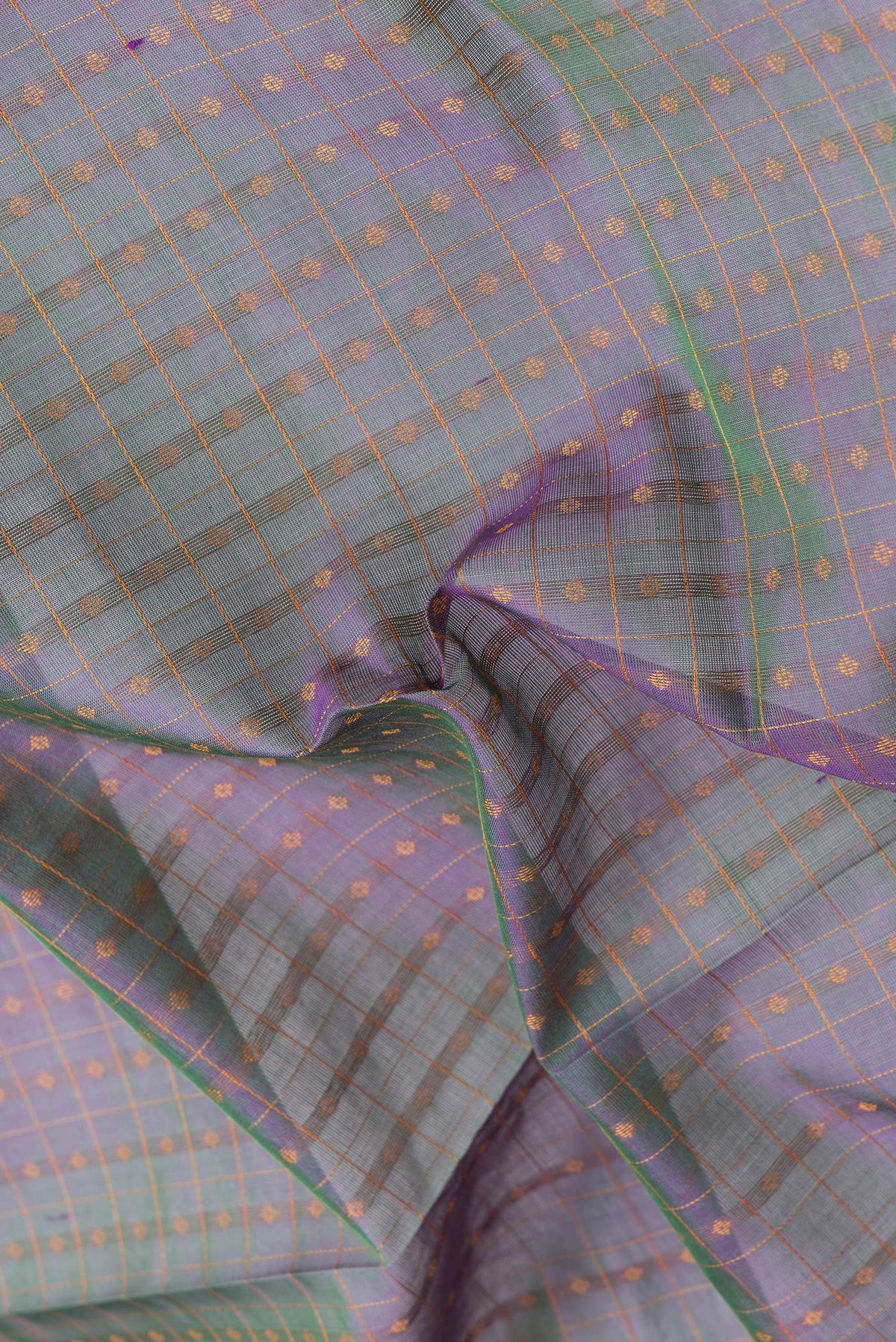 Close up of Green Dual Tone Silk Cotton Saree with Thread Butta on the body and Zari Border.  displaying folds