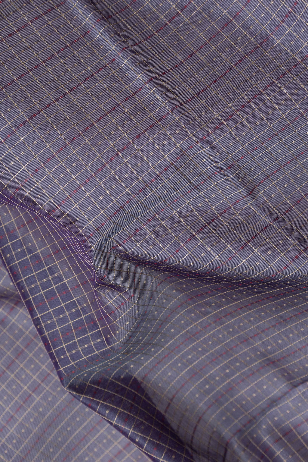 Close up of Grey Silk Cotton Saree with Checked design on the body and Zari Border.  displaying folds