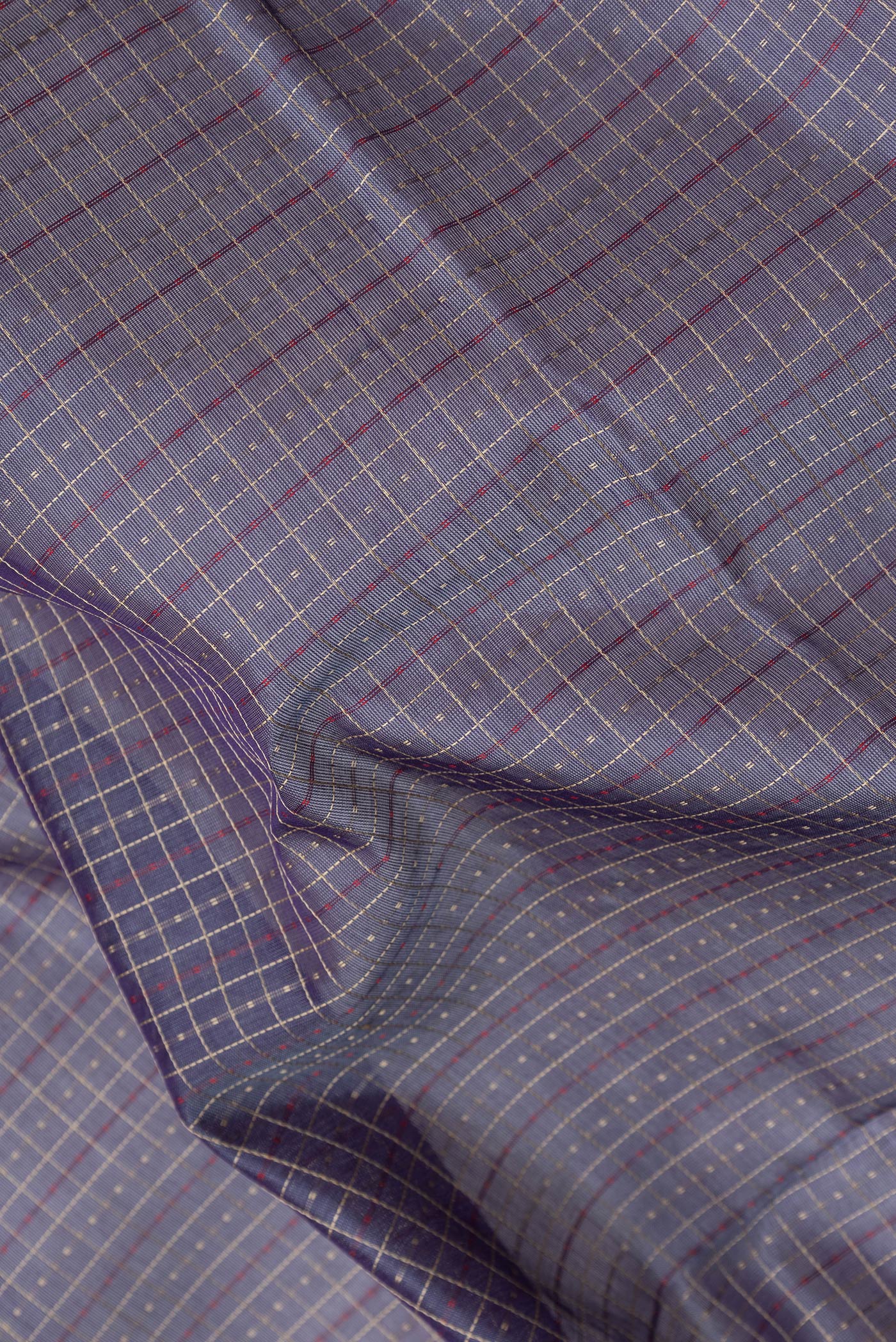 Close up of Grey Silk Cotton Saree with Checked design on the body and Zari Border.  displaying folds