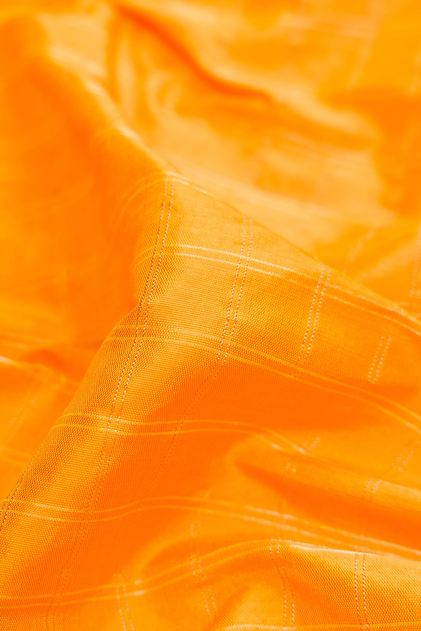 Close up of Yellow Dual Tone Paithani Silk Saree with Checked design on the body and Paithani Border displaying folds