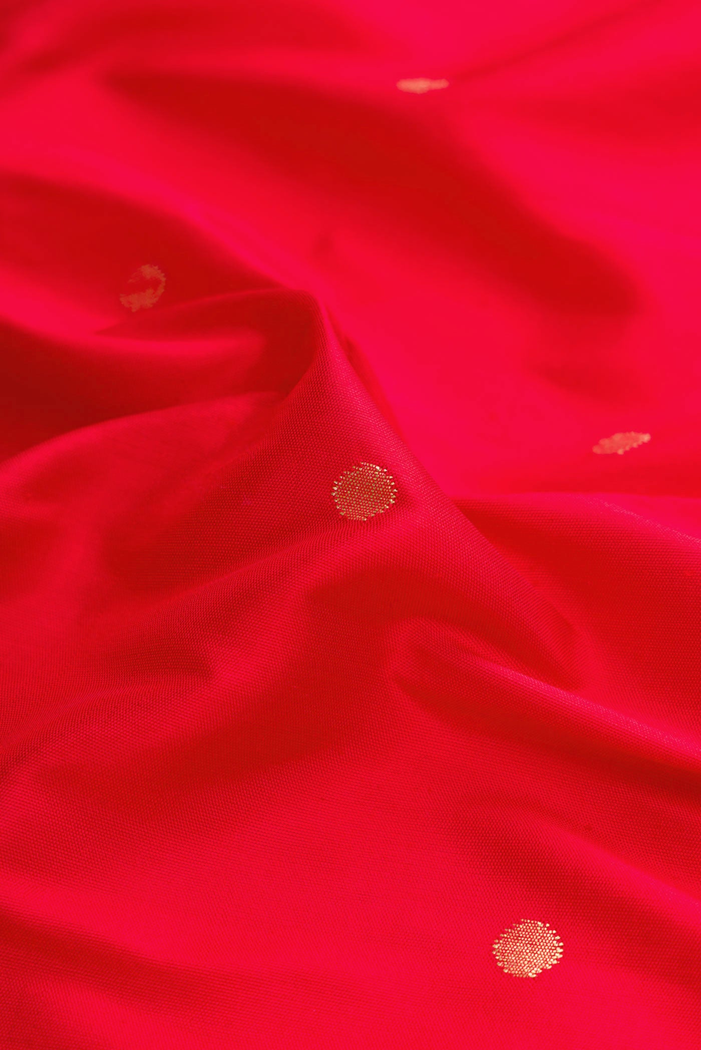 Close up of Red Dual Tone Paithani Silk Saree with Zari Butta on the body and Paithani Border displaying folds