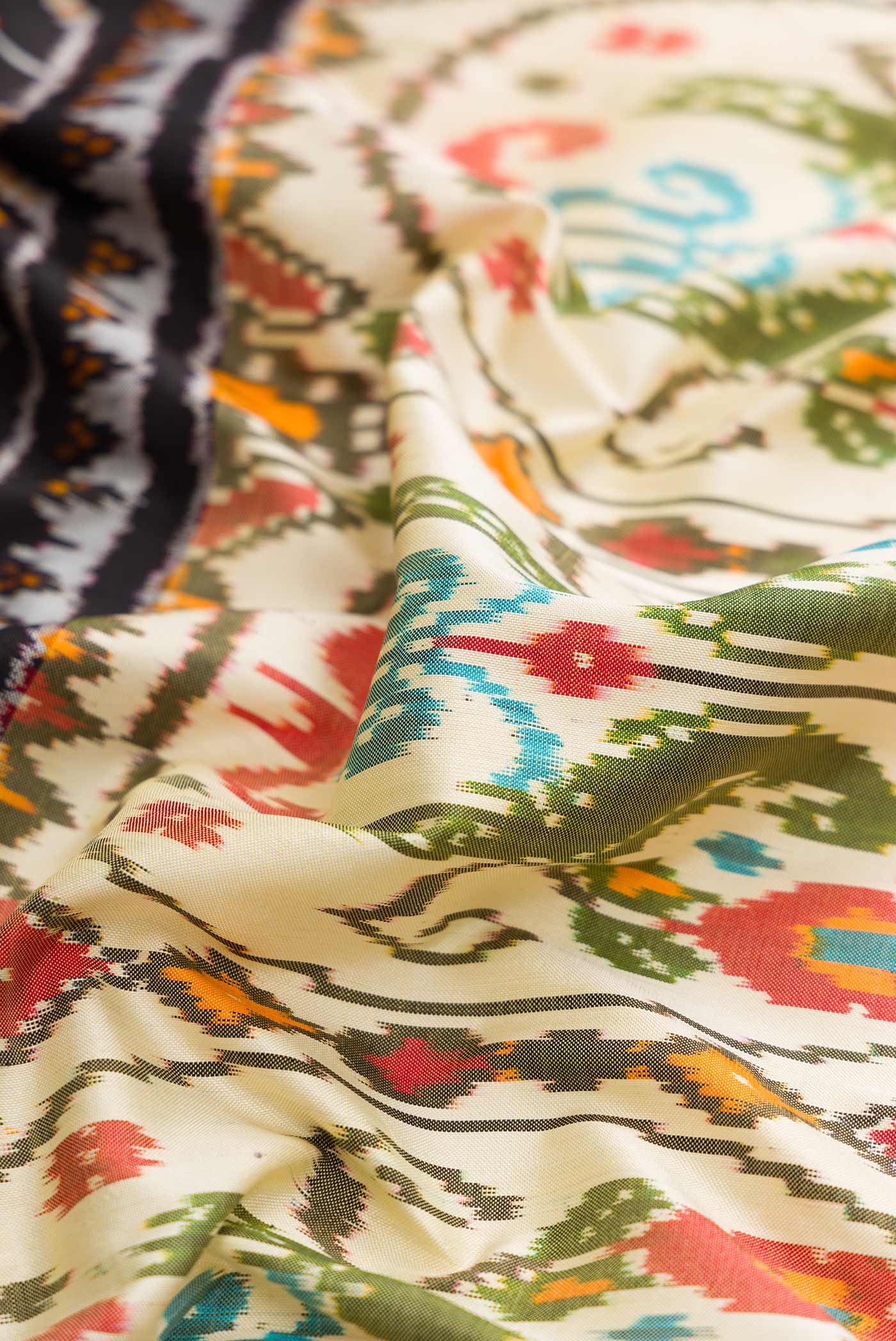 Close up of Beige Dual Tone Double Ikat Saree with Printed design on the body and Paithani Border displaying folds
