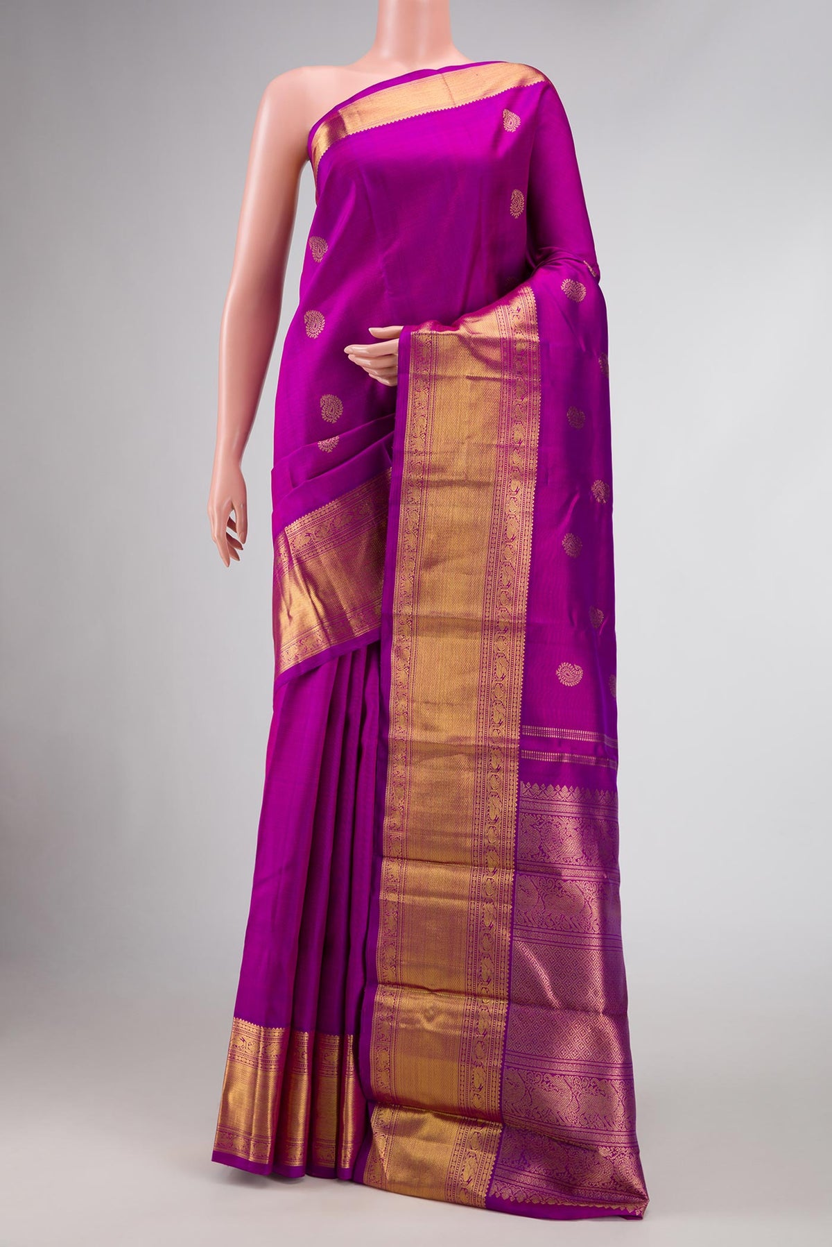 Pure Silk Pure Zari Purple Dual Tone Kanjivaram Saree with Zari Butta on the body and Zari Border.  displayed on a mannequin