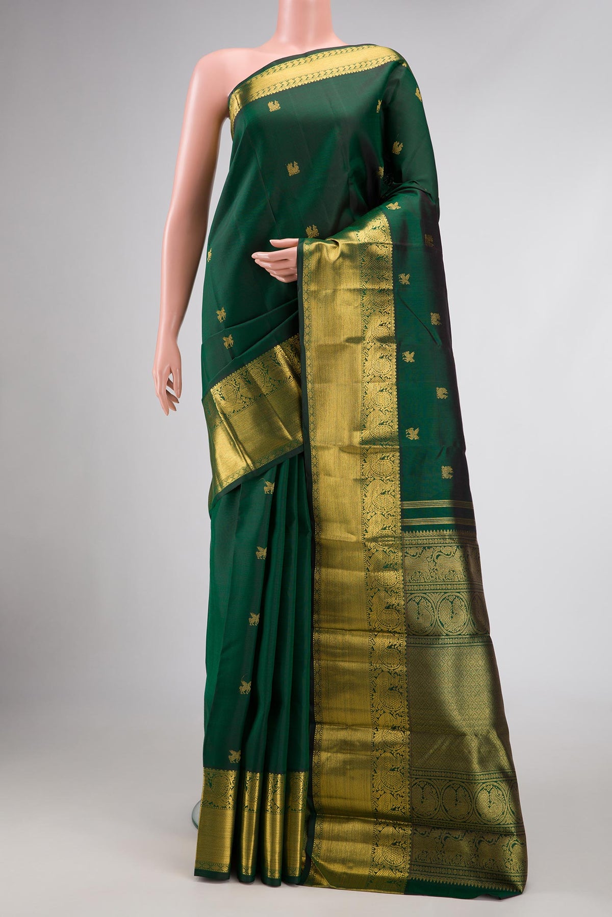 Pure Silk Pure Zari Bottle Green Dual Tone Kanjivaram Saree with Zari Butta on the body and Zari Border.  displayed on a mannequin
