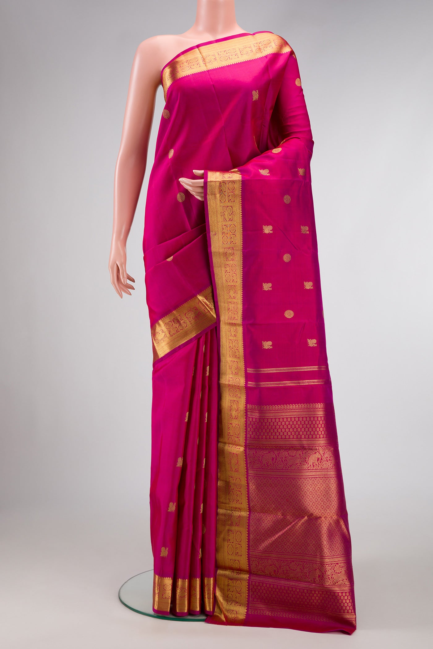 Pure Silk Pure Zari Magenta Dual Tone Kanchipuram Saree with Zari Butta on the body and Zari Border.  displayed on a mannequin