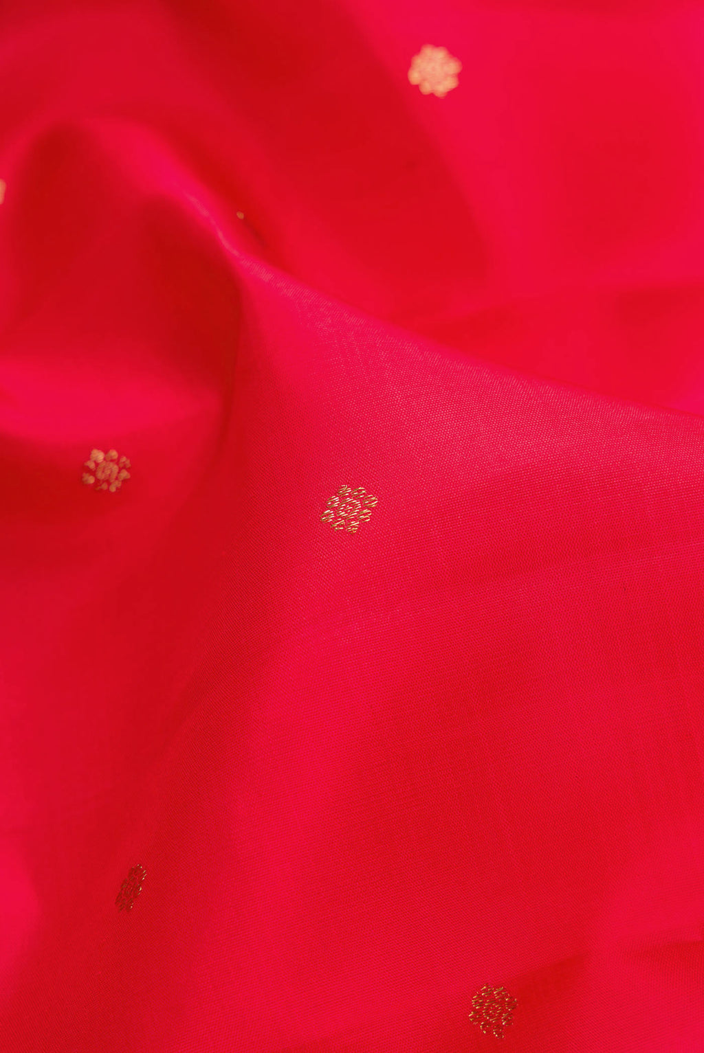 Close up of Pure Silk Pure Zari Red Dual Tone Kanchipuram Saree with Zari Butta on the body and Zari Border.  displaying folds