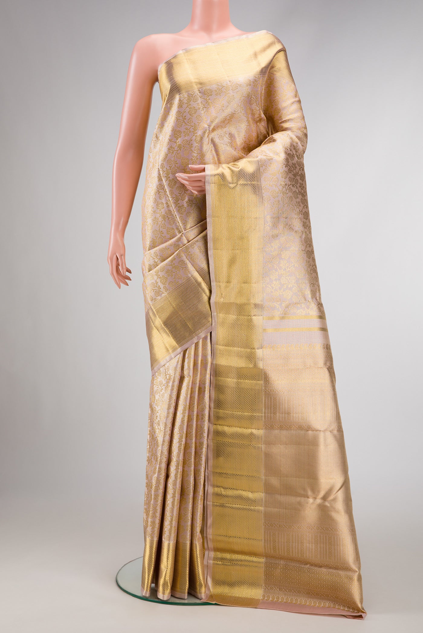 Pure Silk Pure Zari Rose Gold Dual Tone Kanjivaram Tissue Saree with Zari Brocade on the body and Zari Border.  displayed on a mannequin