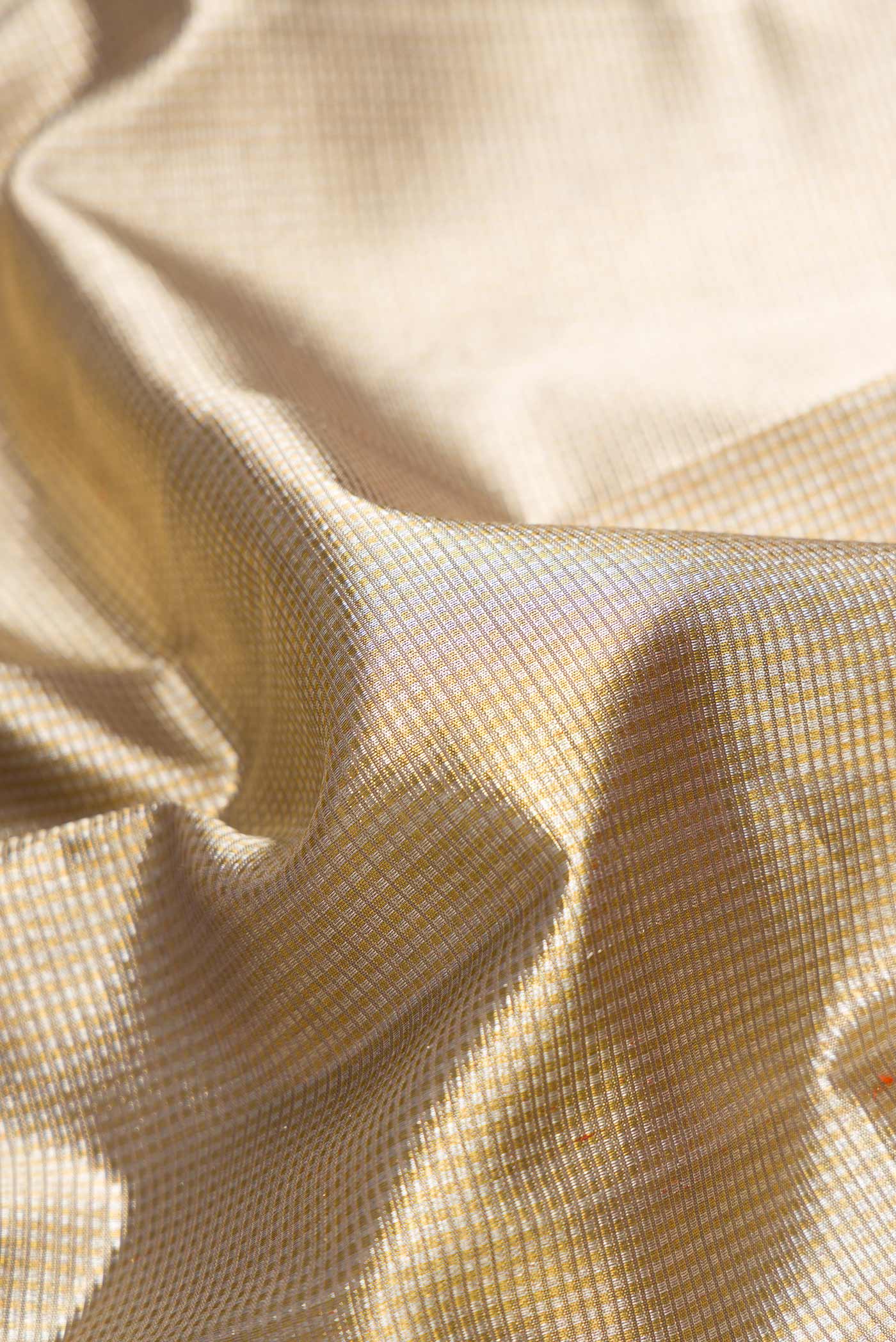 Close up of Pure Silk Pure Zari Grey Dual Tone Kanjivaram Tissue Saree with Zari Brocade on the body and Zari Border.  displaying folds