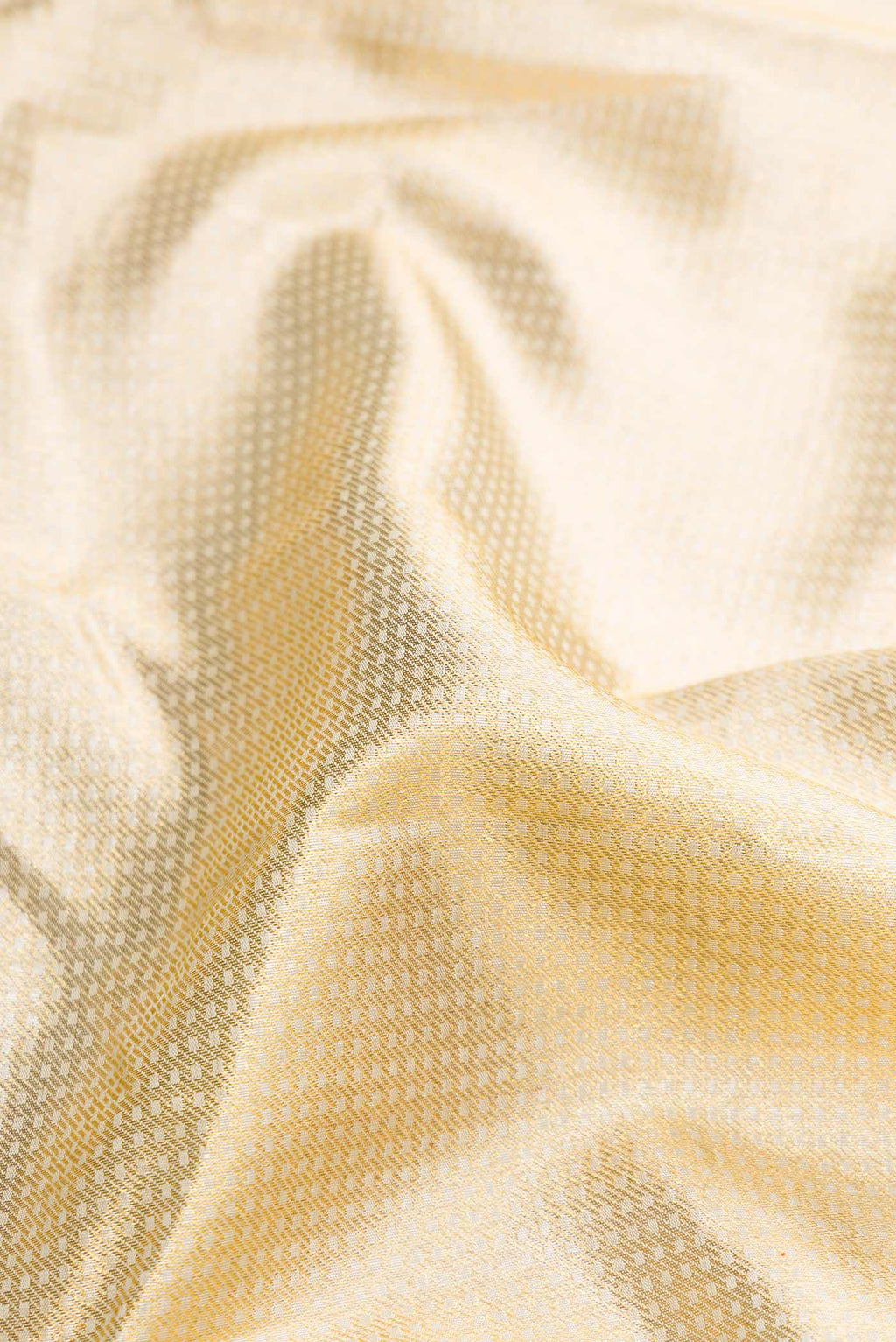 Close up of Pure Silk Pure Zari Gold Dual Tone Kanchipuram Saree with Zari Brocade on the body and Zari Border displaying folds