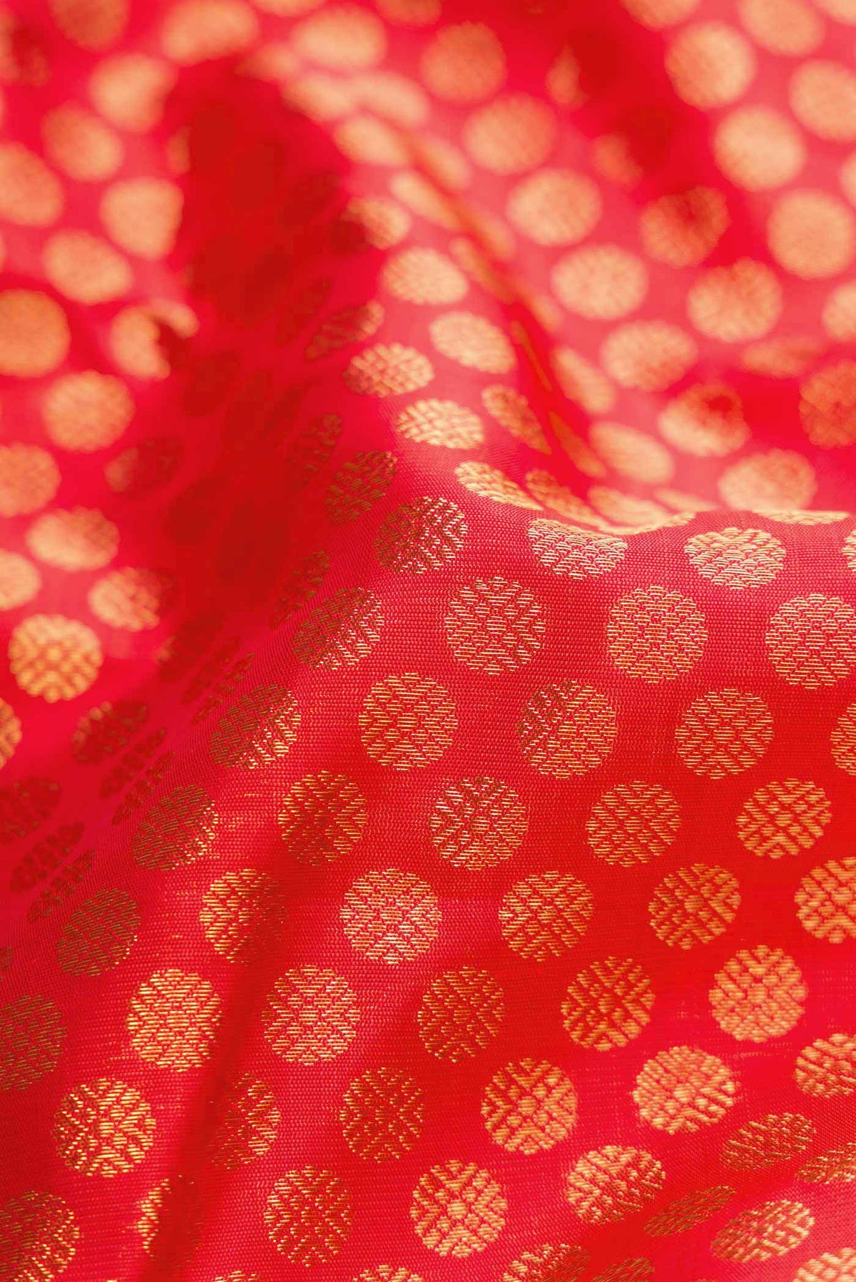 Close up of Pure Silk Pure Zari Red Dual Tone Kanchipuram Saree with Zari Brocade on the body and Zari Border displaying folds