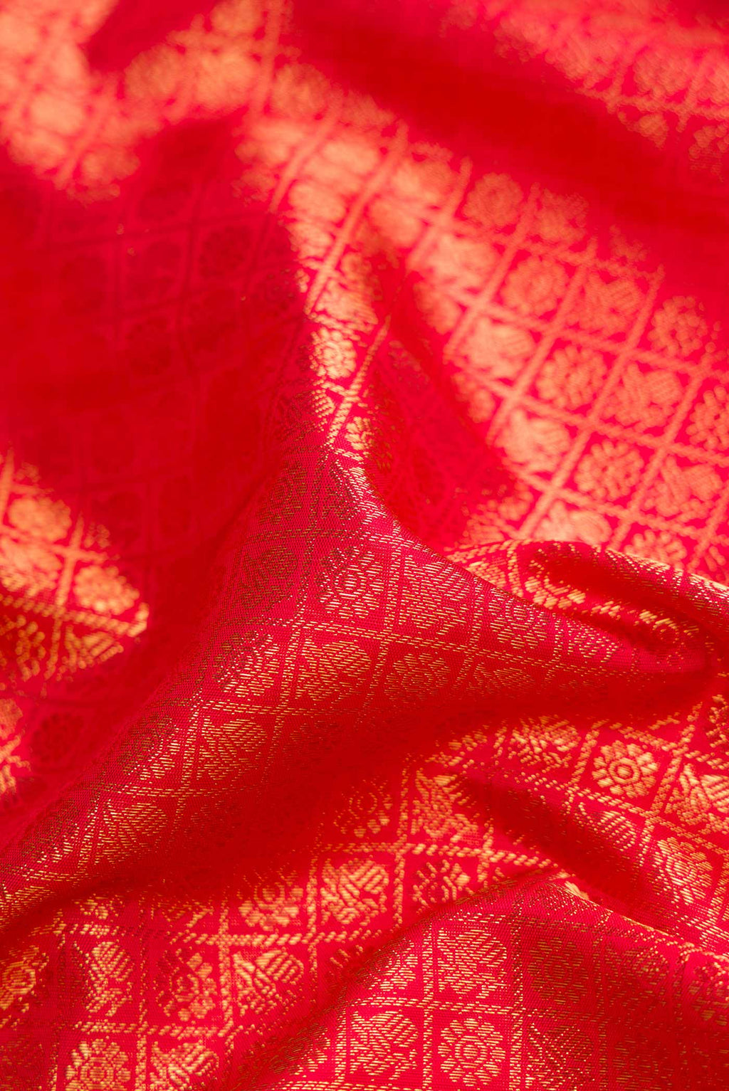 Close up of Pure Silk Pure Zari Red Dual Tone Kanchipuram Saree with Zari Brocade on the body and Zari Border displaying folds