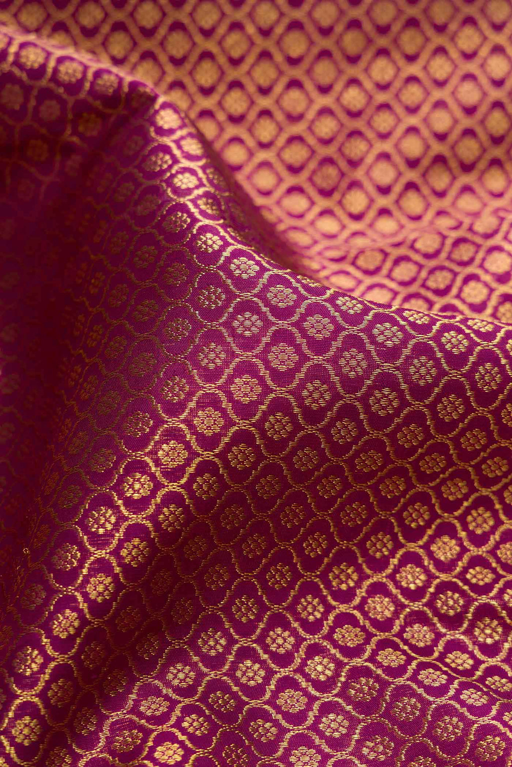 Close up of Pure Silk Pure Zari Purple Dual Tone Kanjivaram Tissue Saree with Zari Brocade on the body and Zari Border.  displaying folds