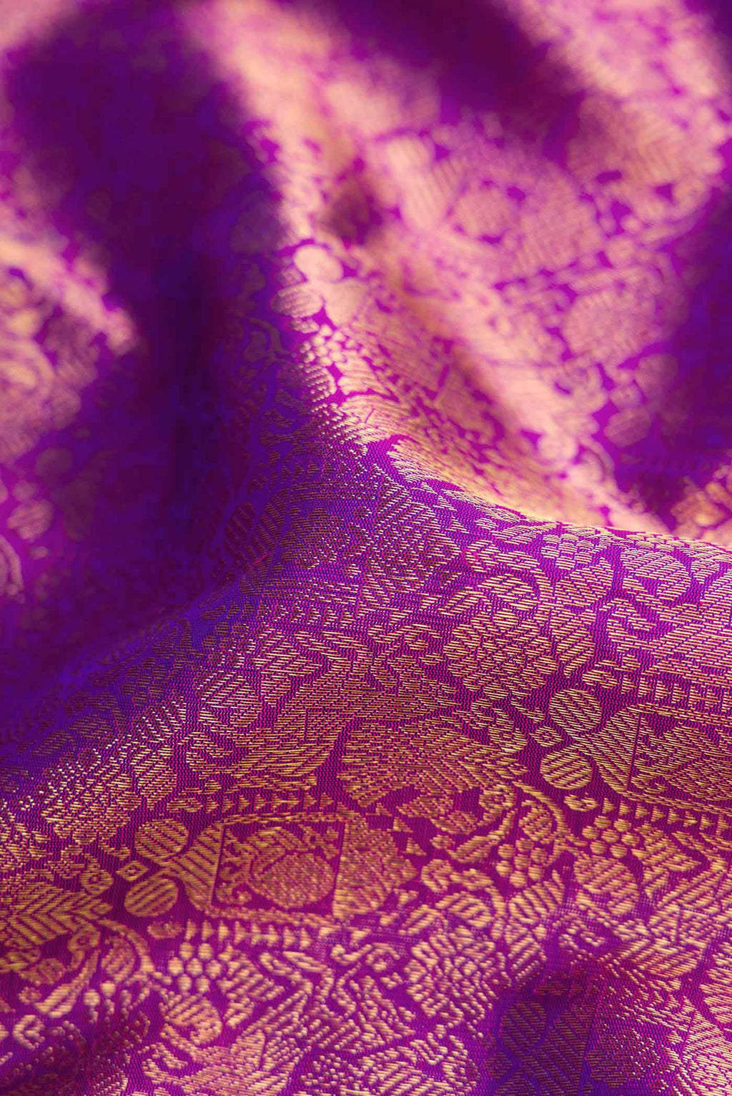Close up of Pure Silk Pure Zari Purple Kanchipuram Saree with Zari Brocade on the body and Zari Border displaying folds