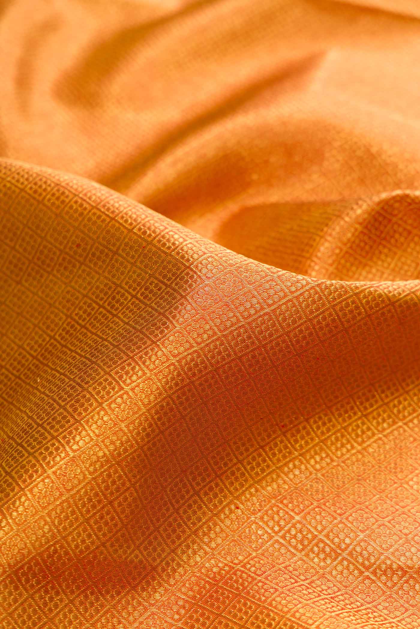 Close up of Pure Silk Pure Zari Mustard Dual Tone Kanchipuram Saree with Zari Brocade on the body and Zari Border displaying folds