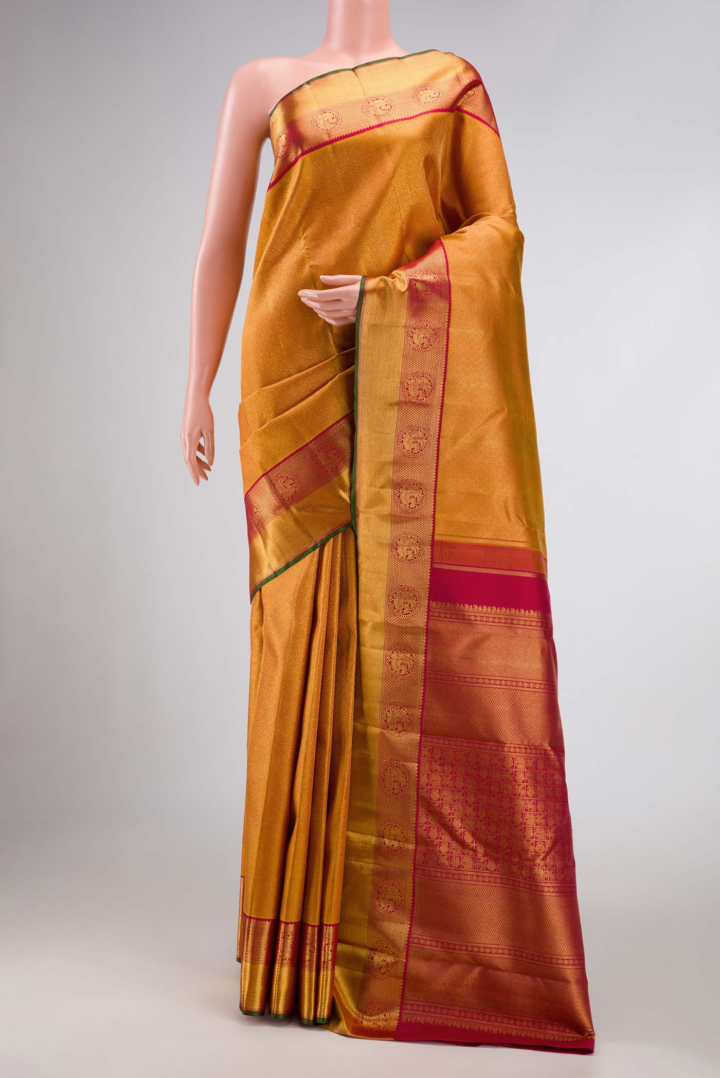 Pure Silk Pure Zari Mustard Dual Tone Kanchipuram Saree with Zari Brocade on the body and Zari Border displayed on a mannequin