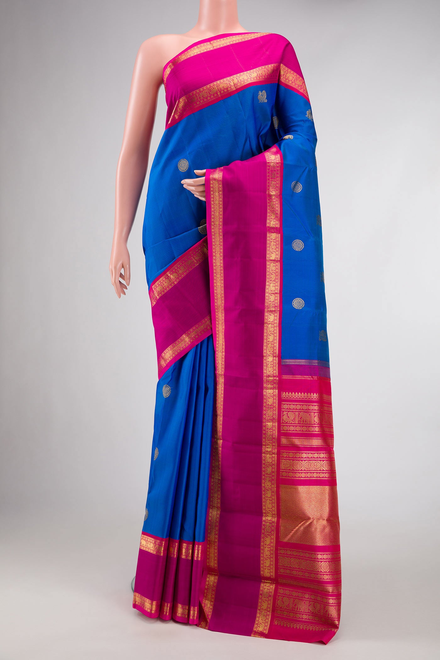 Pure Silk Pure Zari Royal Blue Dual Tone Kanjivaram Saree with Zari Butta on the body and Zari Border.  displayed on a mannequin