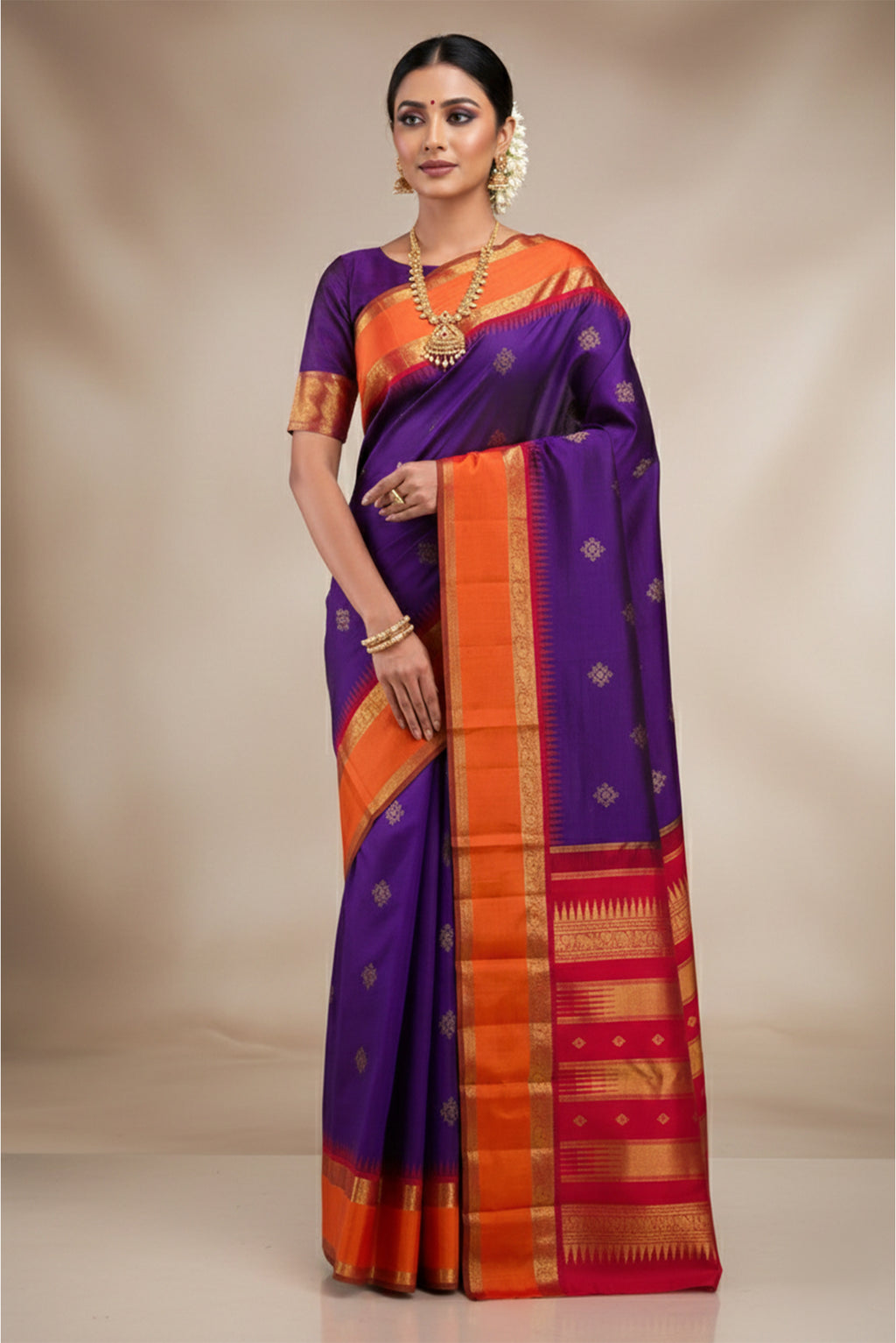Model wearing a Pure Silk Pure Zari Dark Blue Kanchipuram Saree with Zari Butta on the body and Zari Border.