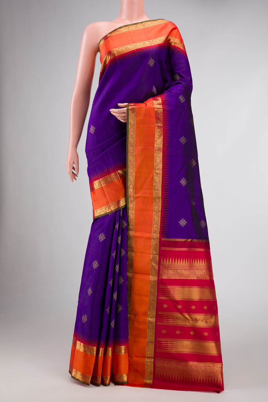 Pure Silk Pure Zari Royal Blue Dual Tone Kanjivaram Saree with Zari Butta on the body and Zari Border.  displayed on a mannequin