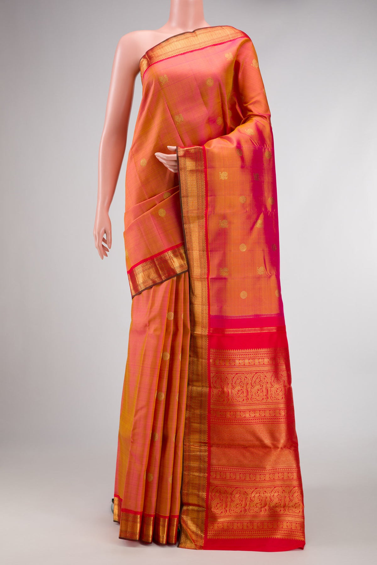 Pure Silk Pure Zari Rose Gold Dual Tone Kanjivaram Saree with Zari Butta on the body and Zari Border.  displayed on a mannequin