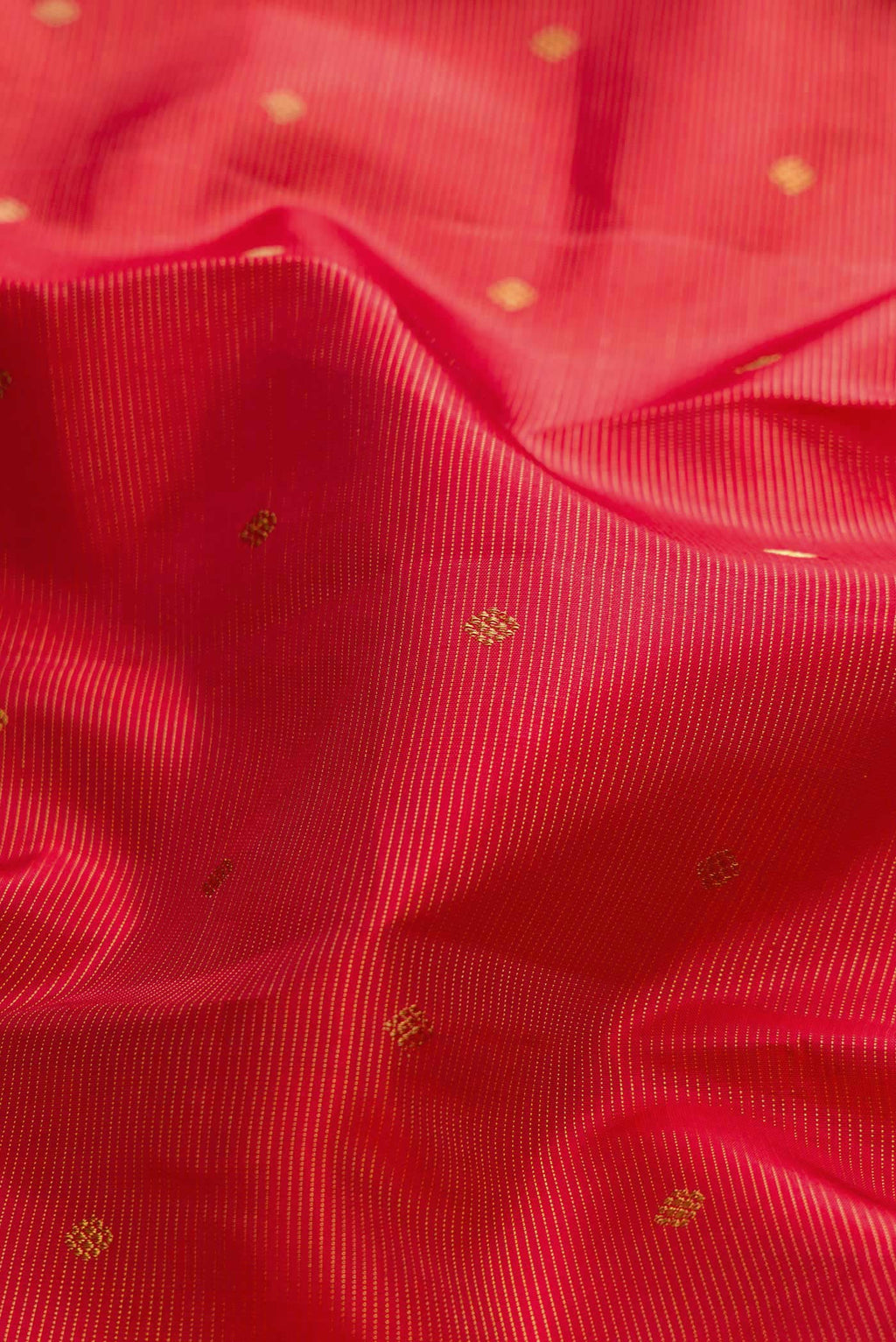 Close up of Pure Silk Pure Zari Maroon Dual Tone Kanchipuram Saree with Zari Butta on the body and Zari Border displaying folds
