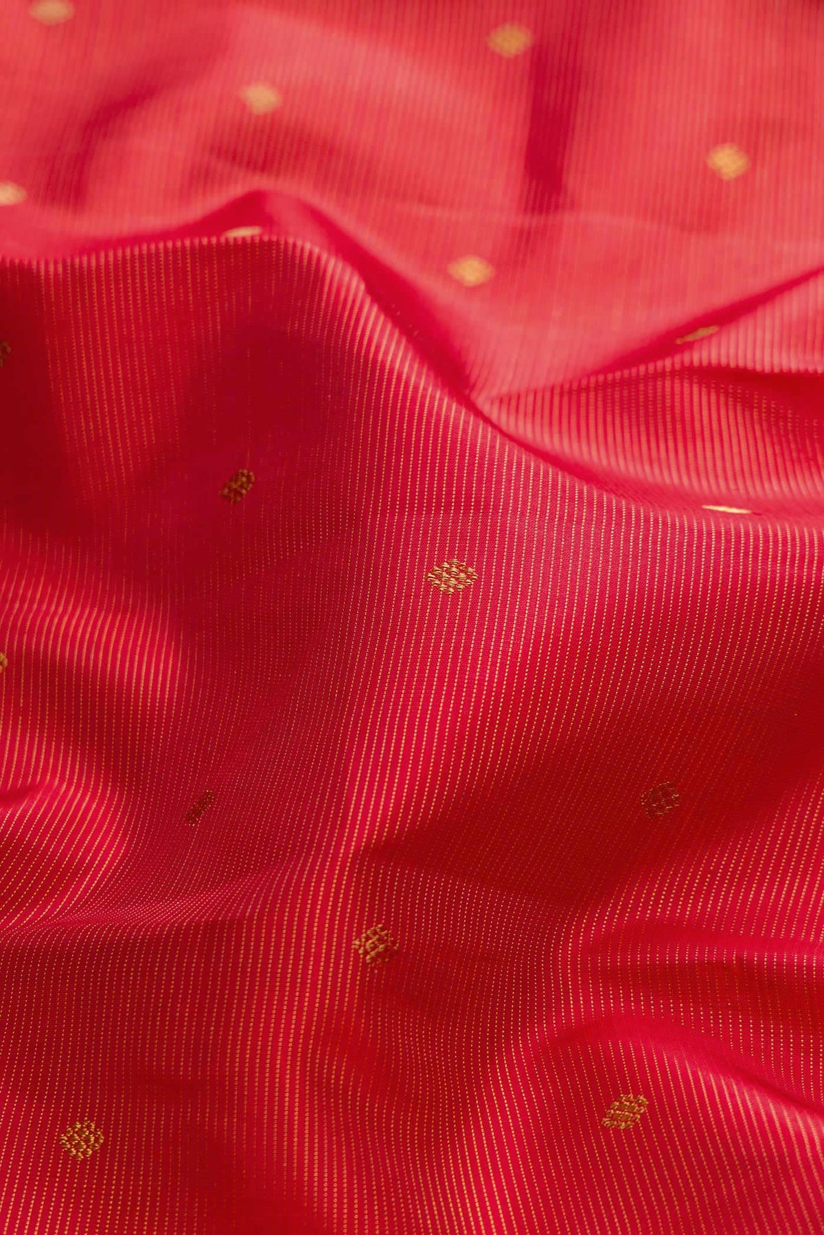 Close up of Pure Silk Pure Zari Maroon Dual Tone Kanchipuram Saree with Zari Butta on the body and Zari Border displaying folds