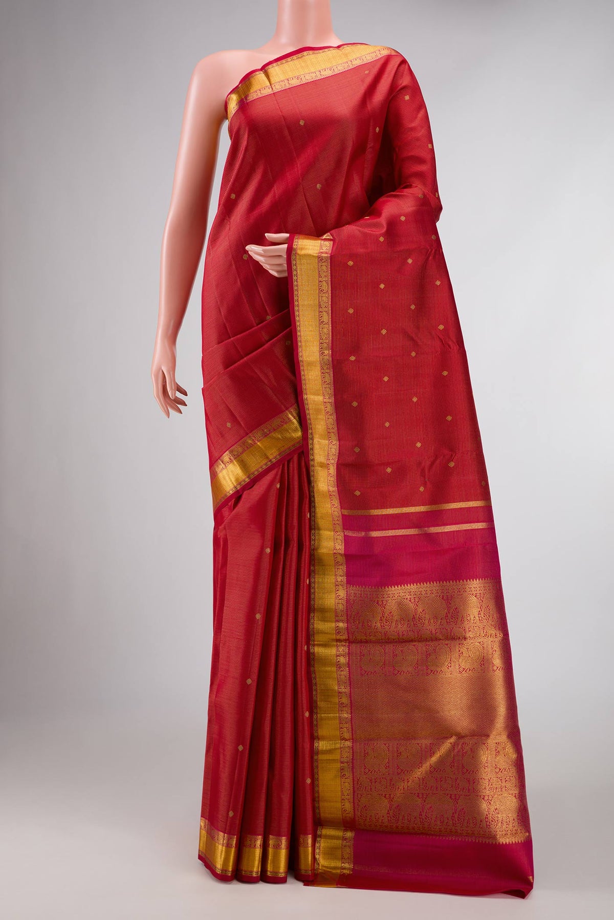 Pure Silk Pure Zari Maroon Dual Tone Kanchipuram Saree with Zari Butta on the body and Zari Border displayed on a mannequin